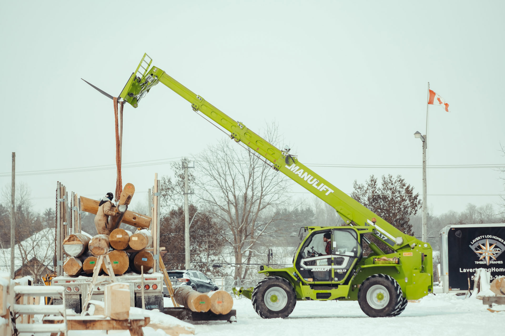 Numbered round logs stickered for transport at the Laverty Log Homes shop in Ontario